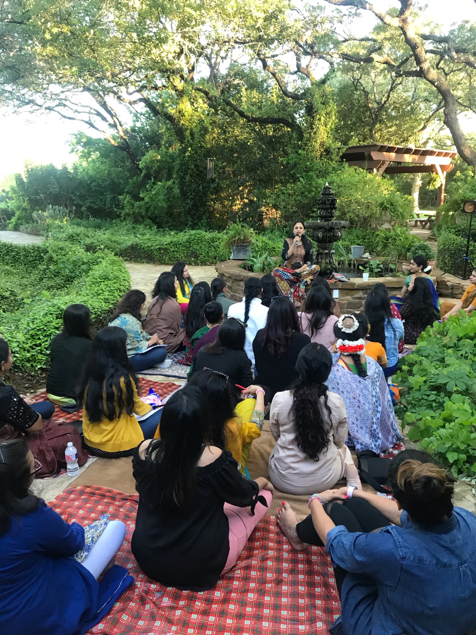 Tat Tvam Asi retreat participants gathered for an outdoor learning circle
