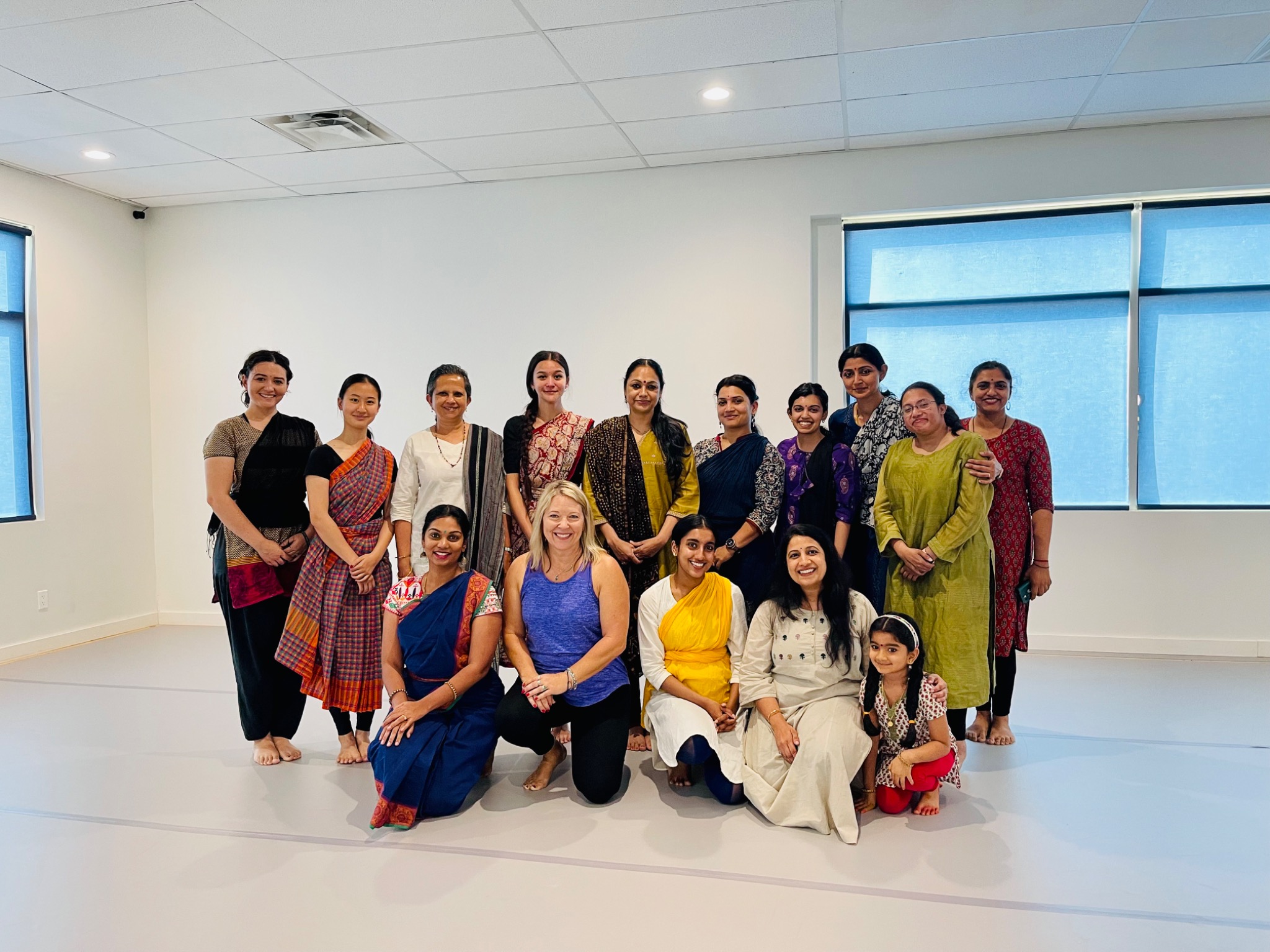 Tat Tvam Asi dancers gathered in a bright studio